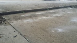 Driveway sunken at street before Concrete Raising Systems, Kansas City,MO 64158