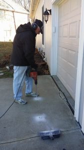 Ken, with Concrete Raising Systems 7318 N Donnelly Ave. Kansas City,MO 64158 drilling holes to shoot foam for concrete driveway repair. 